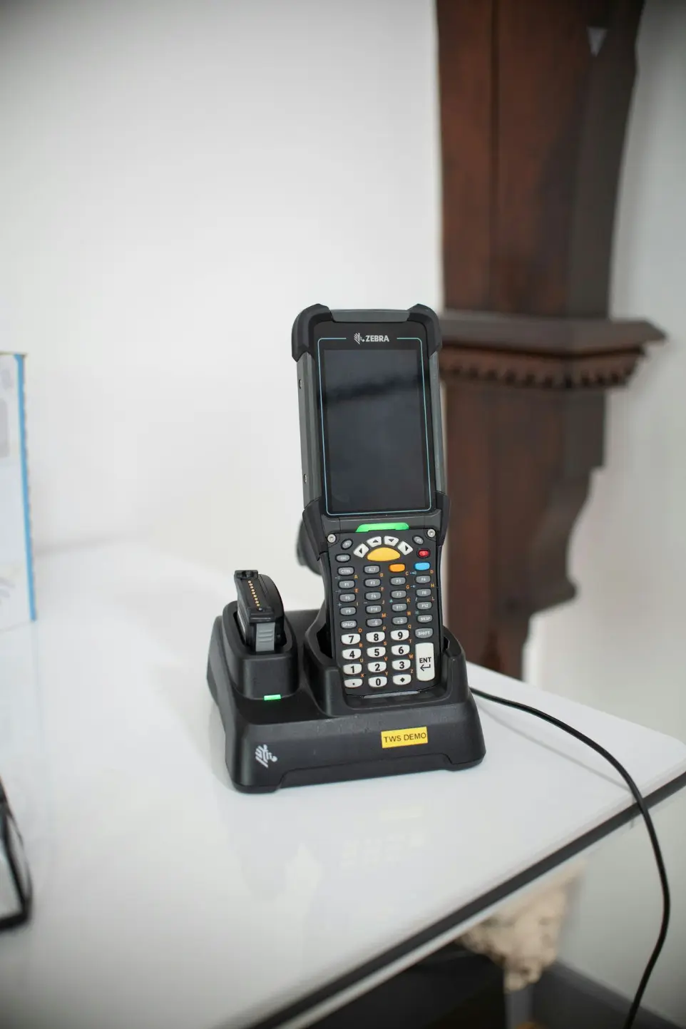 Barcode scanner device in charging dock on table